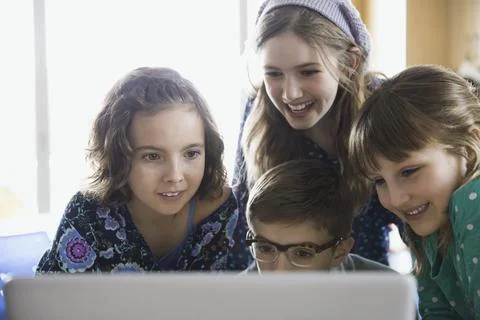 Elementary students using laptop in classroom Stock Photos