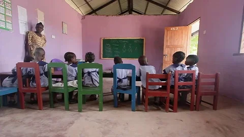 Elementary teacher teaches orphans Stock Footage 69255746