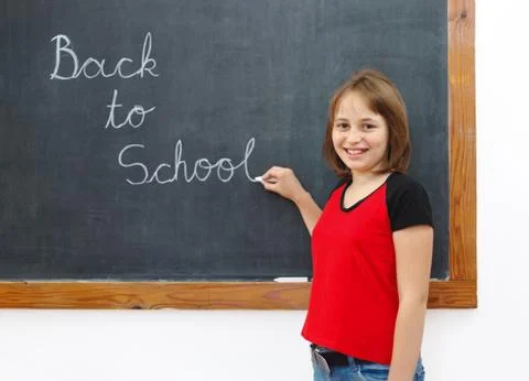 Elementary writing back to school on chalkboard Stock Photos