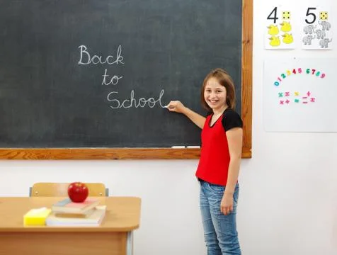 Elementary writing back to school on chalkboard Stock Photos