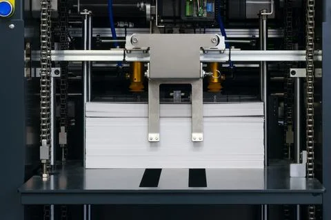 Elements of cardboard boxes are collected in stack. Conveyor line for the pro Foto stock
