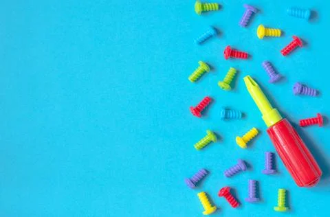 Elements of children's multicolored constructor on a blue background Stock Photos