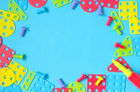 Elements of children's multicolored constructor on a blue background Stock Photos