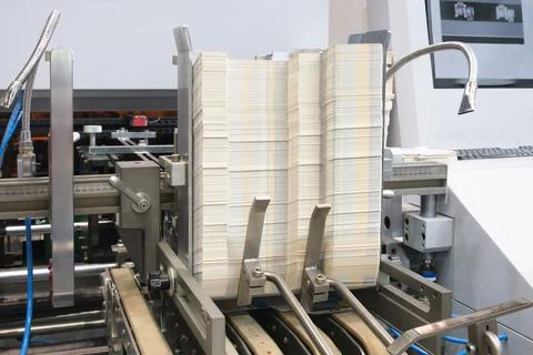 Elements of corton boxes are collected in stack. Conveyor line for the produc 库存照片