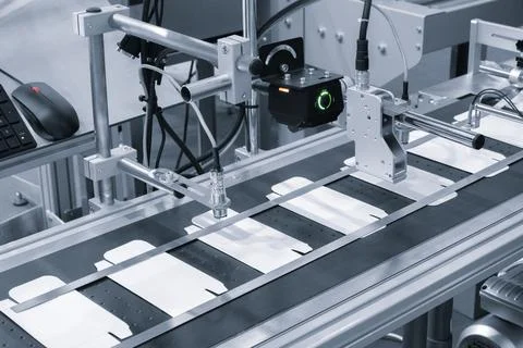 Elements of corton boxes are collected in stack. Conveyor line for the produc Stock Photos