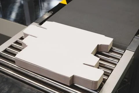 Elements of corton boxes collected in stack. Conveyor line for production of  Stock Photos