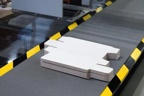 Elements of corton boxes collected in stack. Conveyor line for production of  Stock Photos
