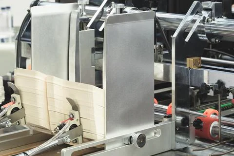 Elements of corton boxes collected in stack. Conveyor line for production of  Stock-Fotos