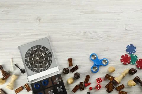 Elements of different board games on white wooden table, flat lay. Space for  库存照片