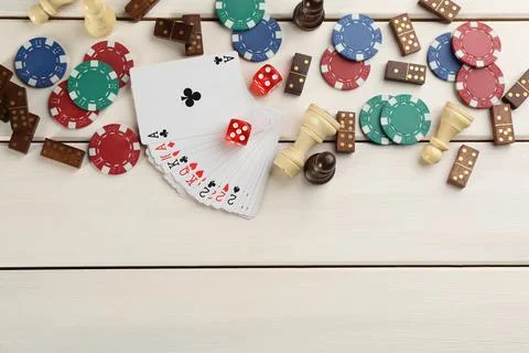 Elements of different board games on white wooden table, flat lay. Space for  写真素材