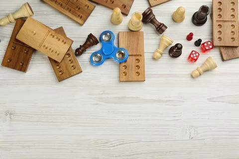 Elements of different board games on white wooden table, flat lay. Space for  스톡 사진