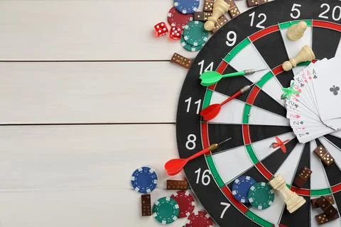 Elements of different board games on white wooden table, flat lay. Space for  Stock Photos