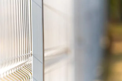 Elements of a metal vertical fence with a strong background blur, the park te Fotos Stock