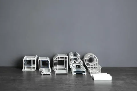 Elements of modern window profile on table against gray wall. Installation se Stockfoto's