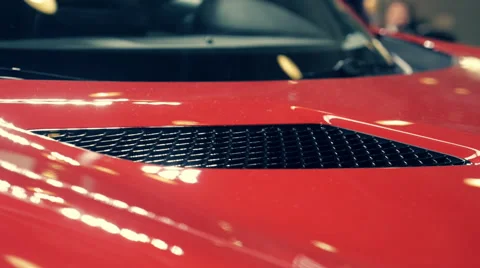 Elements of a red sports car shining on a bright light Stock Footage