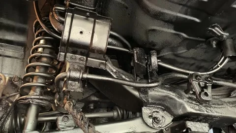 Elements of the running system, the rear axle after processing with black wax. Vídeos de archivo 255042507