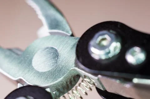 Elements small foldable steel multitool, close up, macro Foto stock