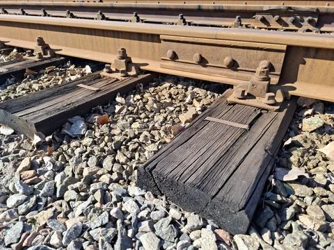 Elements of tram rail system, old wooden sleepers and rusty rails Stock Photos