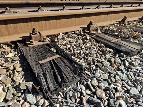 Elements of the tram rail system, old rotten wooden sleepers and rusty rails Stock Photos