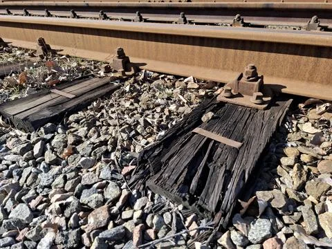 Elements of tramway rail system, old rotten wooden sleepers and rusty rails Stockfoto's