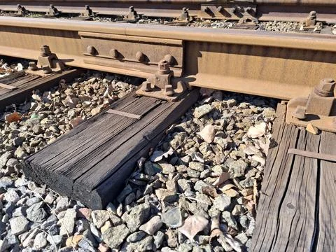 Elements of tramway rail system, old wooden sleepers, rusty rails Stock Photos