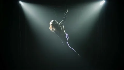 Elements of twine and balancing performed by a female aerial acrobat on an air Stock Footage 138861199