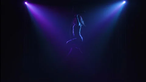 Elements of twine and balancing performed by a female aerial acrobat on an air Stock Footage 138865030