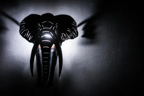 Elephant head lit from behind. Object hanging on the wall. Stock Photos
