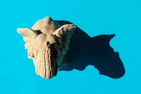 Elephant statuette with a hard shadow on a plain background. the view from the Stock-Fotos