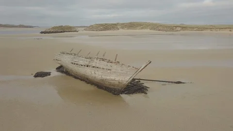 Elevate from Shipwreck on empty beach Video stock 104405324