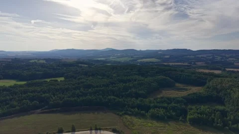 Elevated aerial panorama of patchwork countryside with rolling hills, farmland Stock Footage 345170895
