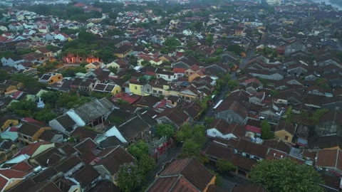 Elevated Aerial View of the Dense Roofscape and Yellow Buildings of Hoi An Stock Footage 318388603