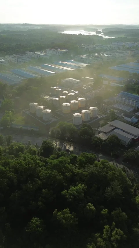 Elevated cinematic sequence revealing a large-scale production complex adja.. Video stock 337284172