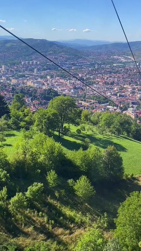 Elevated city view from cable car over green valley Stock Footage 329306522