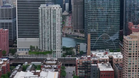 Elevated CTA L train crossing Chicago River downtown with urban skyline, towerin Stock Footage 337314096