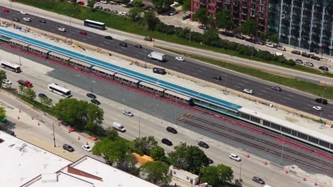 Elevated CTA L Train running alongside Dan Ryan Expressway traffic in Chicago, I Stock Footage 337894825