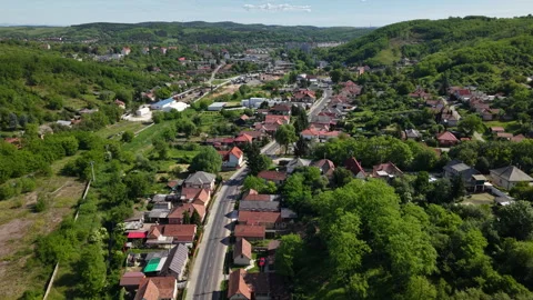 An elevated drone perspective captures a charming village situated within a 库存影片 336634561