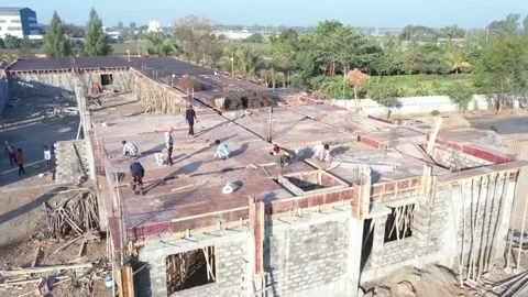 Elevated drone tracking shot documenting an active construction crew installing Stock Footage 337789838
