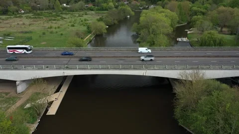 Elevated drone view of continuous traffic flow, featuring cars, vans, trucks, a Stock Footage 308418612