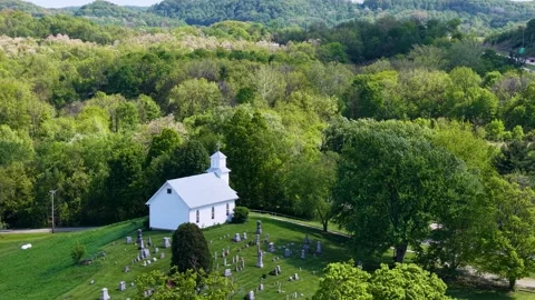 Elevated drone view of an isolated white church at the edge of expansive Stock Footage 341101746