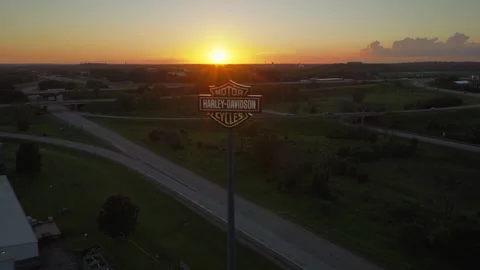 Elevated establishing shot of Harley-Davidson a massive illuminated brand sign Stock Footage 346442648