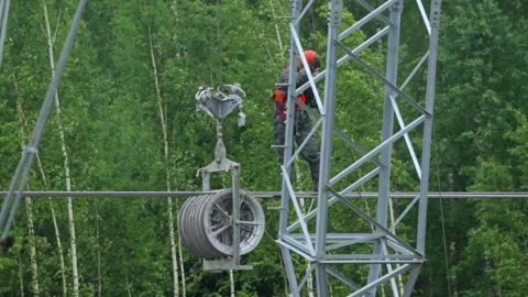 Elevated Expertise: Separator Installation on Power Lines Stock Footage 263539397