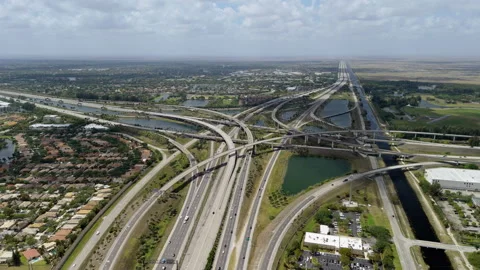 Elevated freeway intersection in Miami city, with fast moving cars. USA Stock Footage 306881543