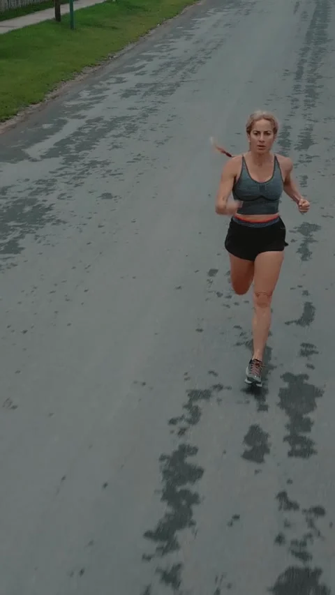 Elevated front view of female runner sprinting toward the camera Stock Footage 340046926