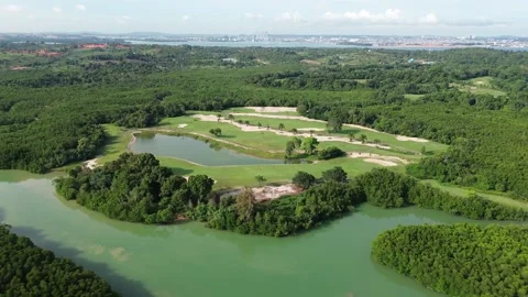 Elevated Glimpse: Lush Golf Landscape Embraced by Emerald Waterways Stock Footage 325200054