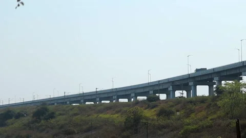 Elevated highway bridge crossing a green river valley Stock Footage 330707900
