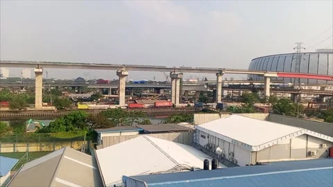 Elevated Highway Bridge Over River JIS Skyline Jakarta Indonesia 4k editorial Stock Footage 336791797