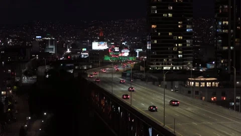 Elevated highway with light trails from moving vehicles cutting through Видео 335946697