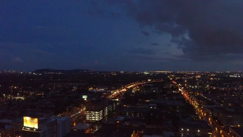 Elevated highway viewed by drone flying at night with city lights Stock Footage 114716493