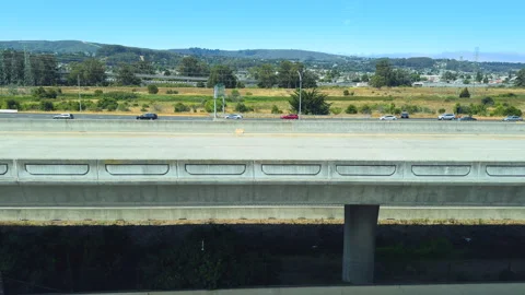 Elevated highways surrounded by dense greenery near San Francisco International Stock Footage 283286302